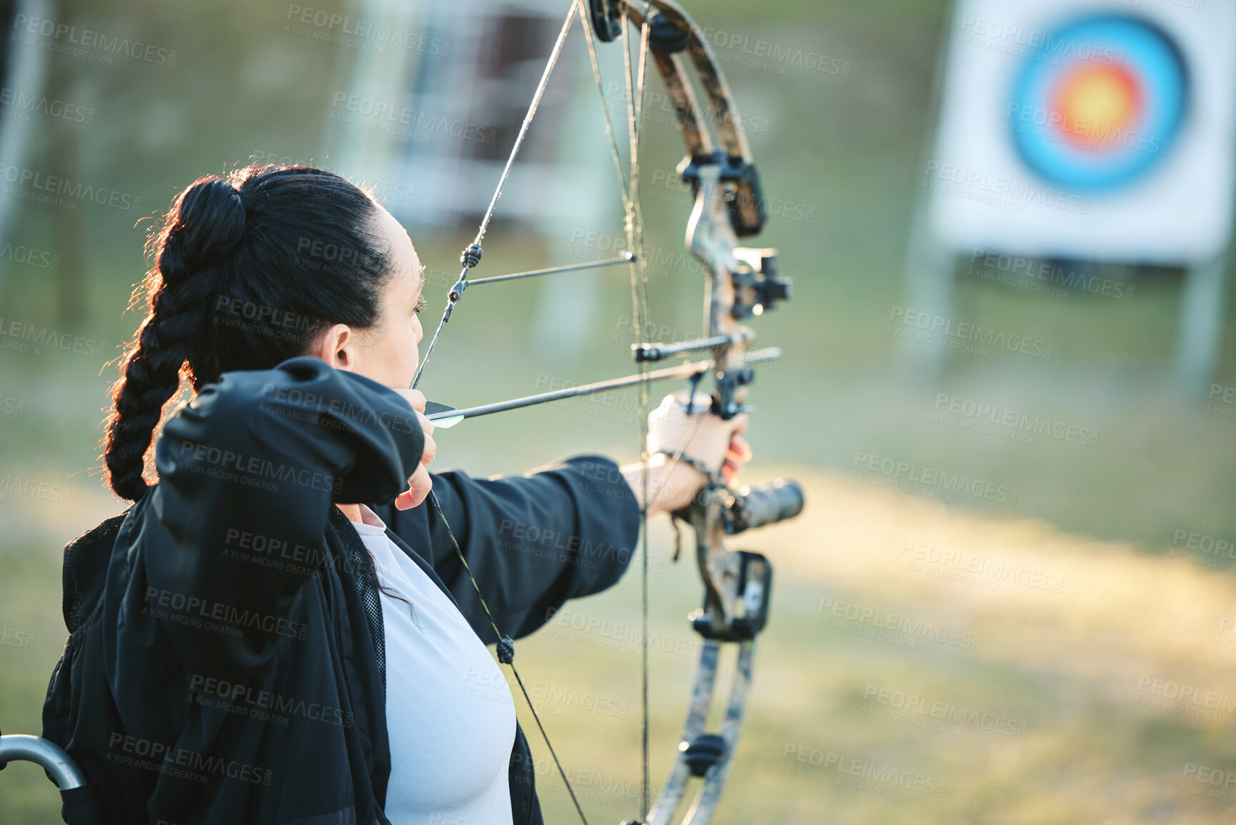 Buy stock photo Archery woman, target and bow and arrow training for outdoor sports, athlete challenge or girl field competition. Shooting goals, talent and competitive archer focus on precision, aim or objective