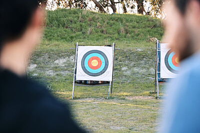 Buy stock photo Target, archery coach or bow and arrow learning for archer competition, athlete challenge or girl training practice. Sports teacher, teaching talk or man coaching woman on precision, aim and shooting