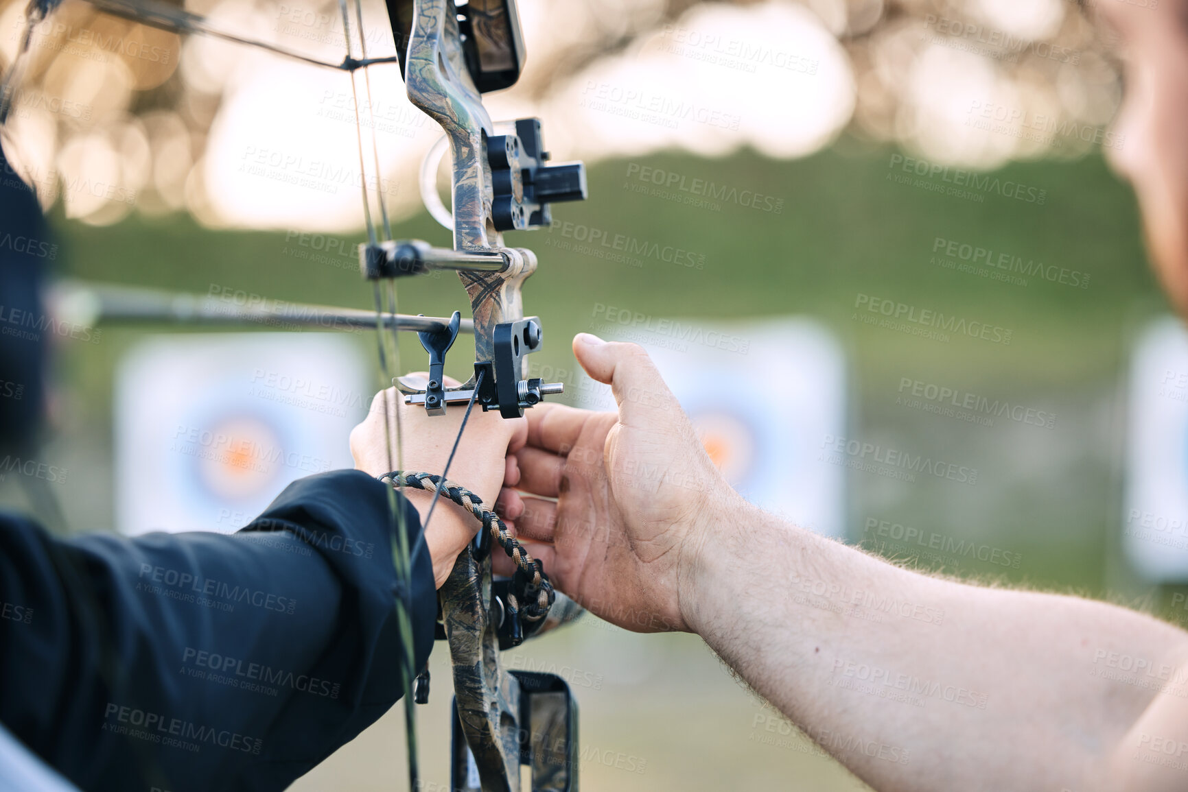 Buy stock photo Hands, archery coach and bow or arrow learning for archer competition, athlete focus challenge or girl training practice. Teacher, teaching and man coaching woman on sports, aim and target shooting