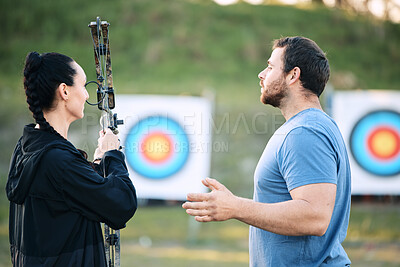 Buy stock photo Sports, archery coach or bow and arrow learning for archer competition, athlete challenge or girl training practice. Teacher, teaching talk or man coaching woman on precision, aim and target shooting