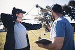 Archery, bow and arrow with woman and coach, aim at target with sports outdoor, combat training and weapon. Coaching, learning and teaching with female and man at shooting range, archer and help