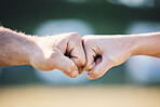 Fist bump, hands and outdoor with touch, teamwork and greeting for respect, support and motivation. Man, woman and hand together for connection, partnership and team building for sport, deal or goal
