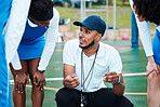Coach, strategy and teamwork with sports people listening to tactics or instructions on a court. Fitness, team and planning with a black man talking to a group of girls during a competition 