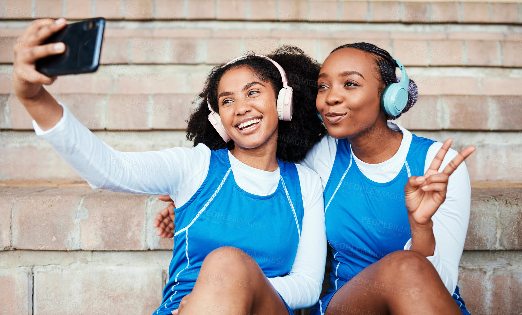 Buy stock photo Selfie, netball and sports women or friends with headphones for training break, social media post and happy music. Athlete black people, teenager or gen z in profile picture and peace emoji hand