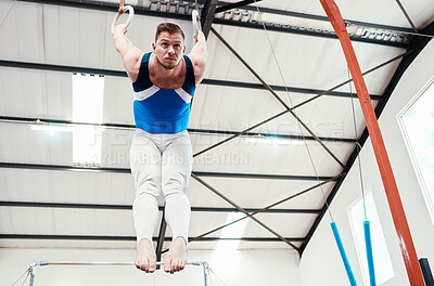 Buy stock photo Man, acrobat and gymnastics balance on rings in fitness for practice, training or workout at gym. Professional male gymnast hanging on ring circles for athletics, acrobatics or strength exercise