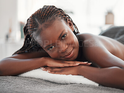 Buy stock photo Spa massage, portrait and black woman on bed for wellness, relax or luxury and zen beauty. Face, girl at resort for body care, therapy or pamper treatment, happy and smile with stress free relaxation