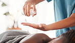 Closeup, spa and hands with oil, black woman and massage to relax, stress relief and luxury treatment. Zoom, female client or masseuse with product for body care, healing or beauty salon for wellness