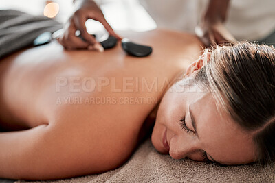 Buy stock photo Woman, hot stone massage and masseuse, hands and zen with holistic therapy and spa treatment for back. Calm, peace of mind and body care, healing and stress relief with self care at wellness resort 