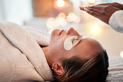 Buy stock photo Eye pads, skincare and woman getting a facial for beauty, self care and cosmetic treatment. Health, relax and calm young female doing a face massage and wellness routine for healthy skin at a spa.