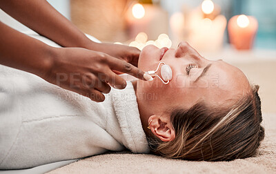 Buy stock photo Face massage, roller and woman at spa with therapist, treatment and skincare, self care and rose quartz. Holistic therapy at luxury resort, healthy skin and wellness, hands and massaging with beauty