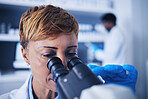 Science, research and woman scientist looking in a microscope to examine for experiment in a lab or laboratory. Doctor, medical and female technician doing sample analysis  for biotechnology