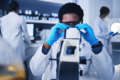 Buy stock photo Microscope, science and black man working on test in laboratory of medical research analysis. Scientist, microbiology and biotechnology technician planning investigation, innovation and dna pathology