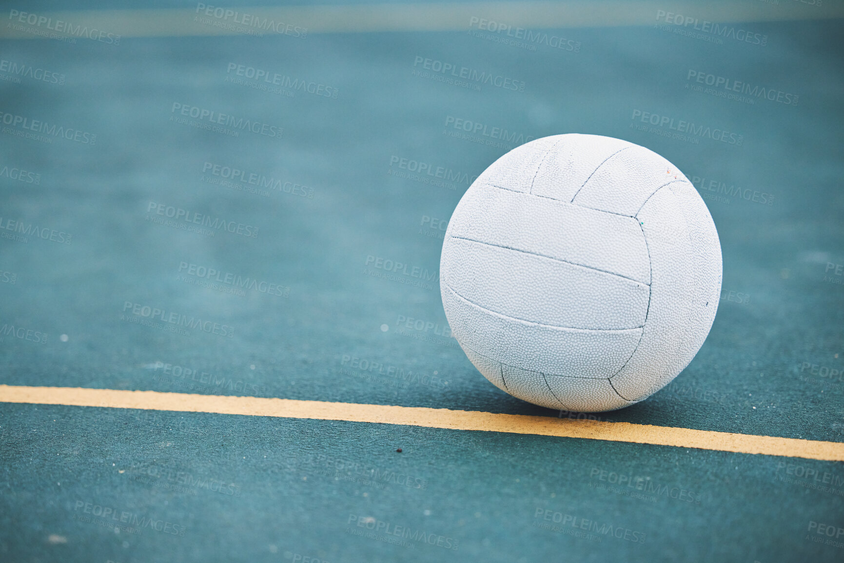 Buy stock photo Netball on the ground on a sports court for a match, training or exercise outdoor on a field. Sport, fitness and white ball on the floor for a game, workout or practice competition by a outside arena