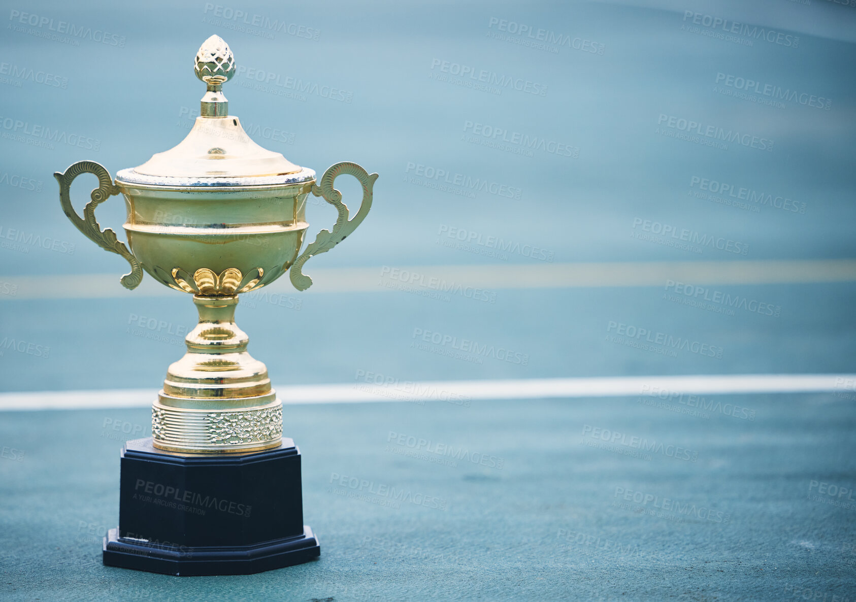 Buy stock photo Sports, award and trophy on the floor with no people at court for success, winner or achievement. Prize, victory and sport reward on a ground at an empty stadium for sport, champion and competition