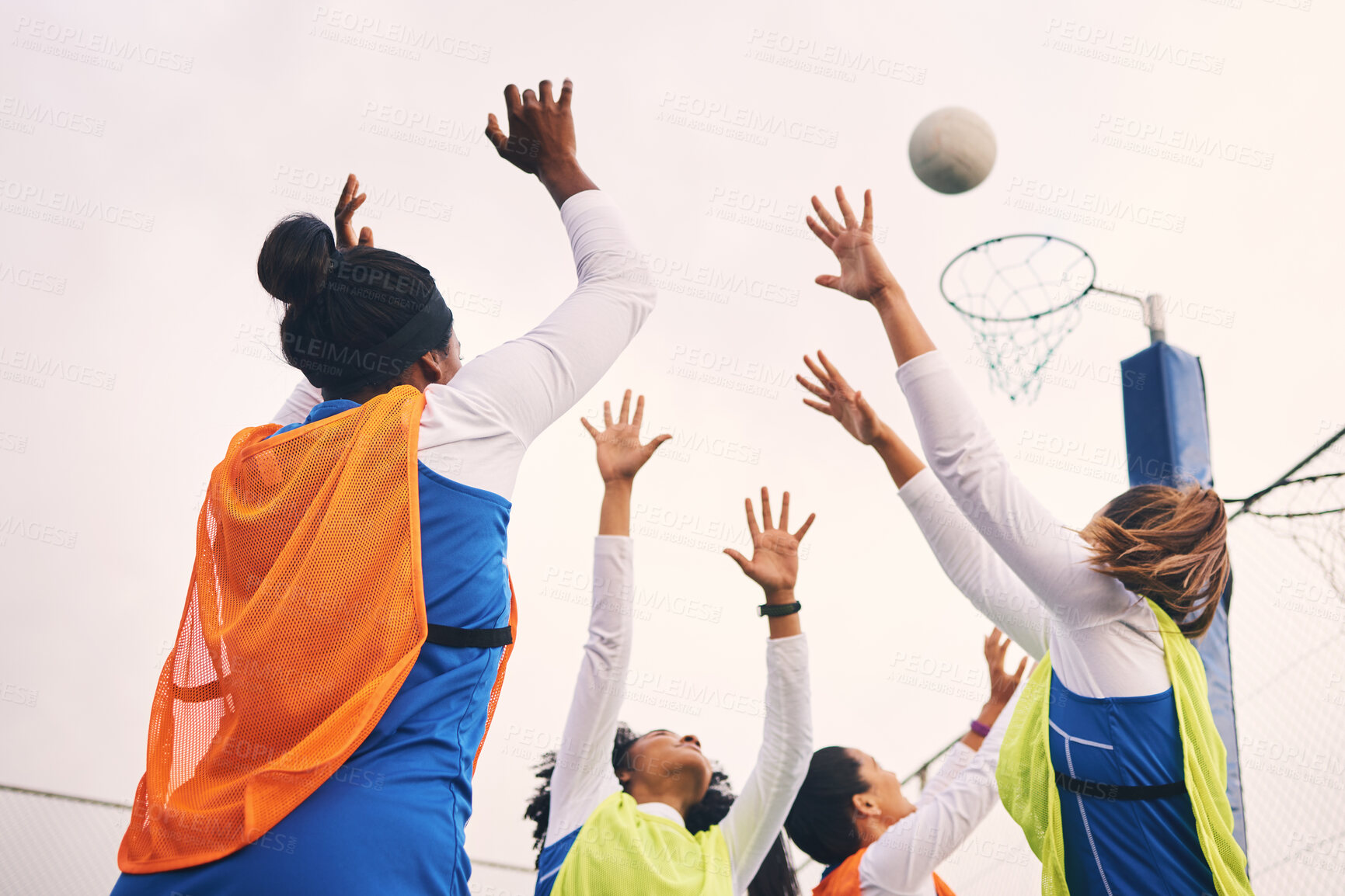 Buy stock photo Netball, goal shooting and fitness of a girl athlete group on an outdoor sports court. Aim, sport game and match challenge of a black person with a ball doing exercise and training in a competition
