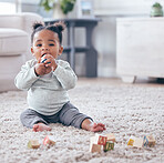 Portrait, baby and building blocks toy on a floor for learning, playing and fun in her home. Face, toddler and girl with block puzzle on a carpet for child development, color and educational skill