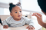 Food, breakfast and parent feeding a baby in the morning while eating porridge with a mother. Hungry, feed and African child ready to eat a meal, lunch or dinner with a mom  in a family home