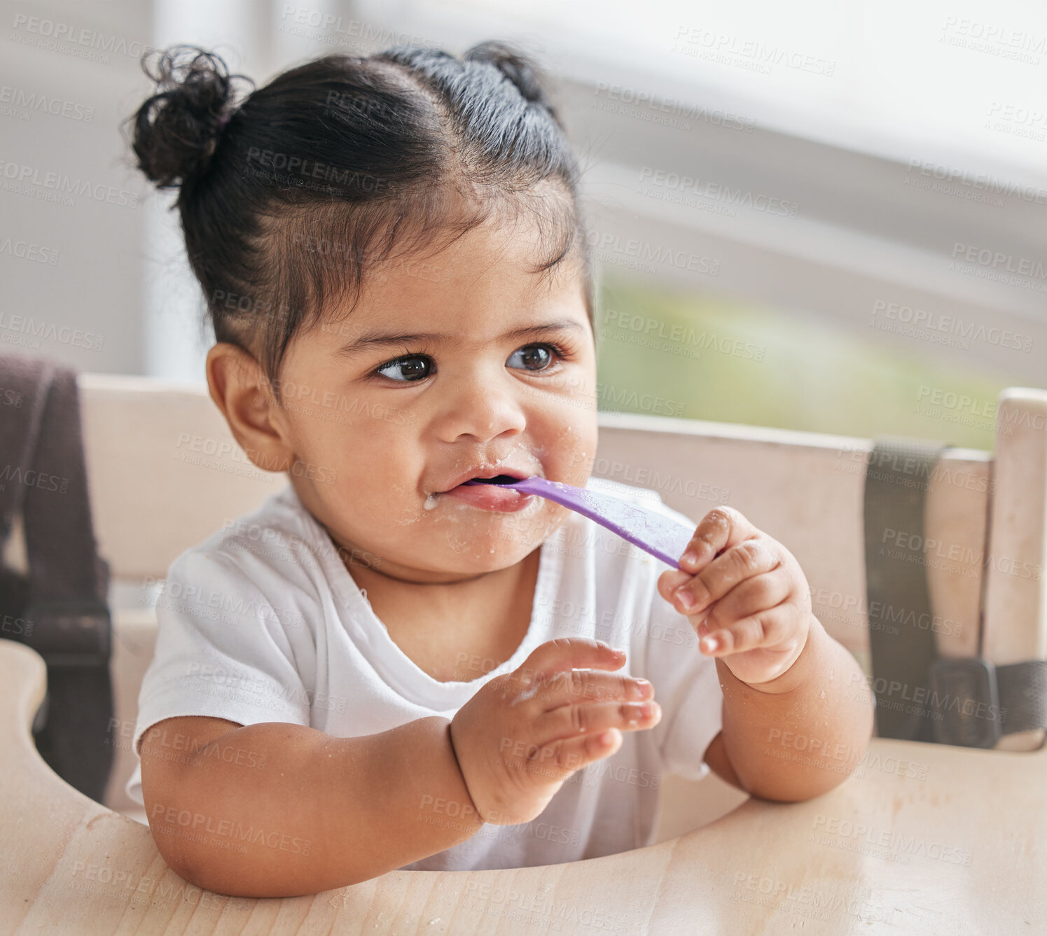 Buy stock photo Baby, eating and girl with toddler food for nutrition and child growth in a kitchen at home. Youth, hungry and spoon of a kid in the morning on a children high chair in a house getting fed a meal