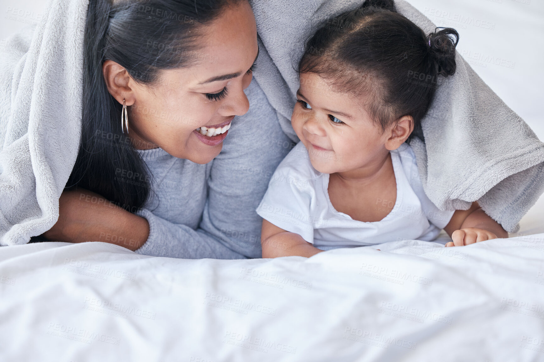 Buy stock photo Happy, morning and mother with a baby and blanket for comfort, relaxing and laughing together. Smile, cute and mom resting in bed with a child while bonding, playing and quality time with a kid