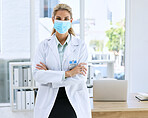 Woman, doctor and portrait with mask and arms crossed standing in confidence for healthcare by laptop office desk. Confident or proud female medical professional in medicine ready for medicare help