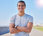 Fitness, smile and running with portrait of man for health, sports and marathon training. Wellness, workout and exercise with athlete and arms crossed in outdoors for cardio, jogging and happy