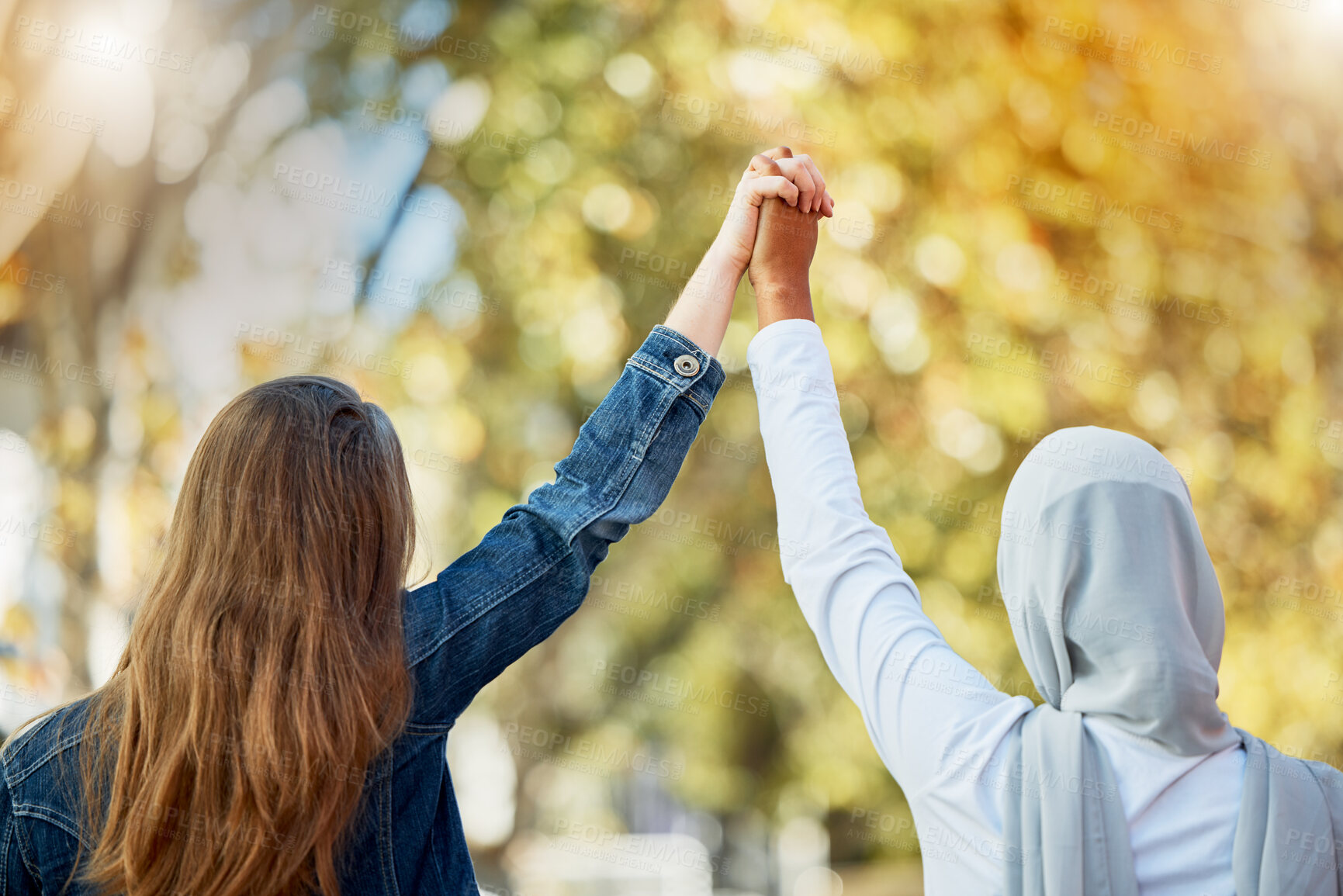 Buy stock photo Support, love and women holding hands for unity, trust and solidarity in nature while on a walk. Freedom, multicultural and female friends with an affection gesture while walking in a park or garden.