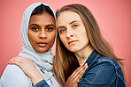 Portrait, hug and lesbian couple with relationship freedom isolated on a pink background in a studio. Diversity, friendship and serious women with affection, caring and hugging as friends on backdrop