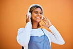 Mockup, wall and black woman with headphones, smile and streaming music against studio background. African American female, girl and headset for audio, relax and listen to radio, songs and podcast