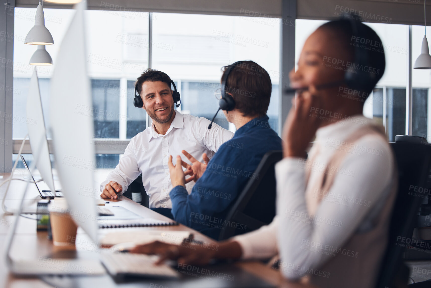 Buy stock photo Call center, telemarketing and employees talking, customer service and explain system in office. Team, coworkers and consultants in workplace, tech support and conversation for process and training