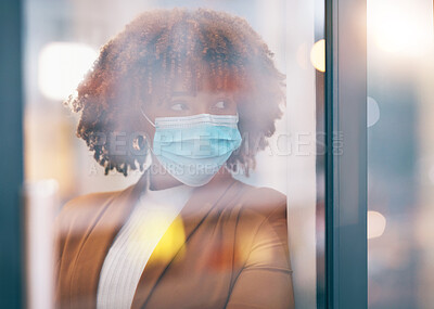 Buy stock photo Covid, window and thinking with a business black woman in her office, standing by a glass pane alone. Idea, safety and mask with a female employee in her workplace during the corona virus pandemic