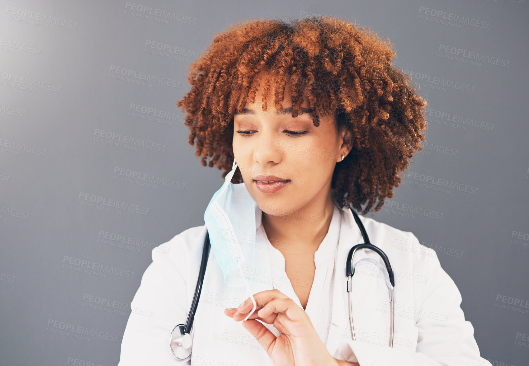 Buy stock photo Black woman, doctor and covid 19, remove face mask and health, end of pandemic and protection on studio background. Serious, mockup space with healthcare, safety and post coronavirus with female