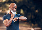 Black man, exercise and smartwatch to check heart rate and listening to music and running outdoor. Senior person with watch in nature forest for workout, fitness and training for health and wellness
