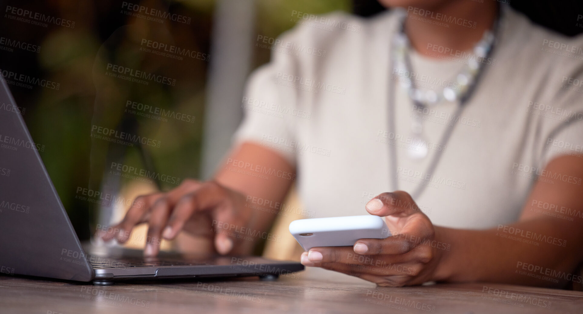 Buy stock photo Black woman, hands and laptop with phone for communication, social media or chatting on table. Hand of African American female freelancer in remote work on computer and smartphone in multitasking