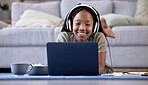 Black woman, student and laptop with smile for elearning, education or entertainment by living room sofa at home. Happy African American female learner smiling on computer lying on lounge floor