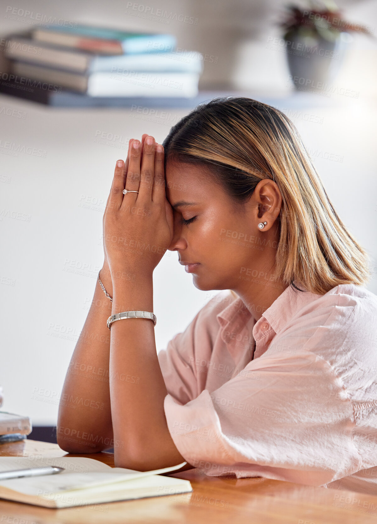 Buy stock photo Black woman, praying hands and books for religion, faith and god help, holy support and spiritual guidance in study. Prayer, hope and christian person or sad university student with bible education