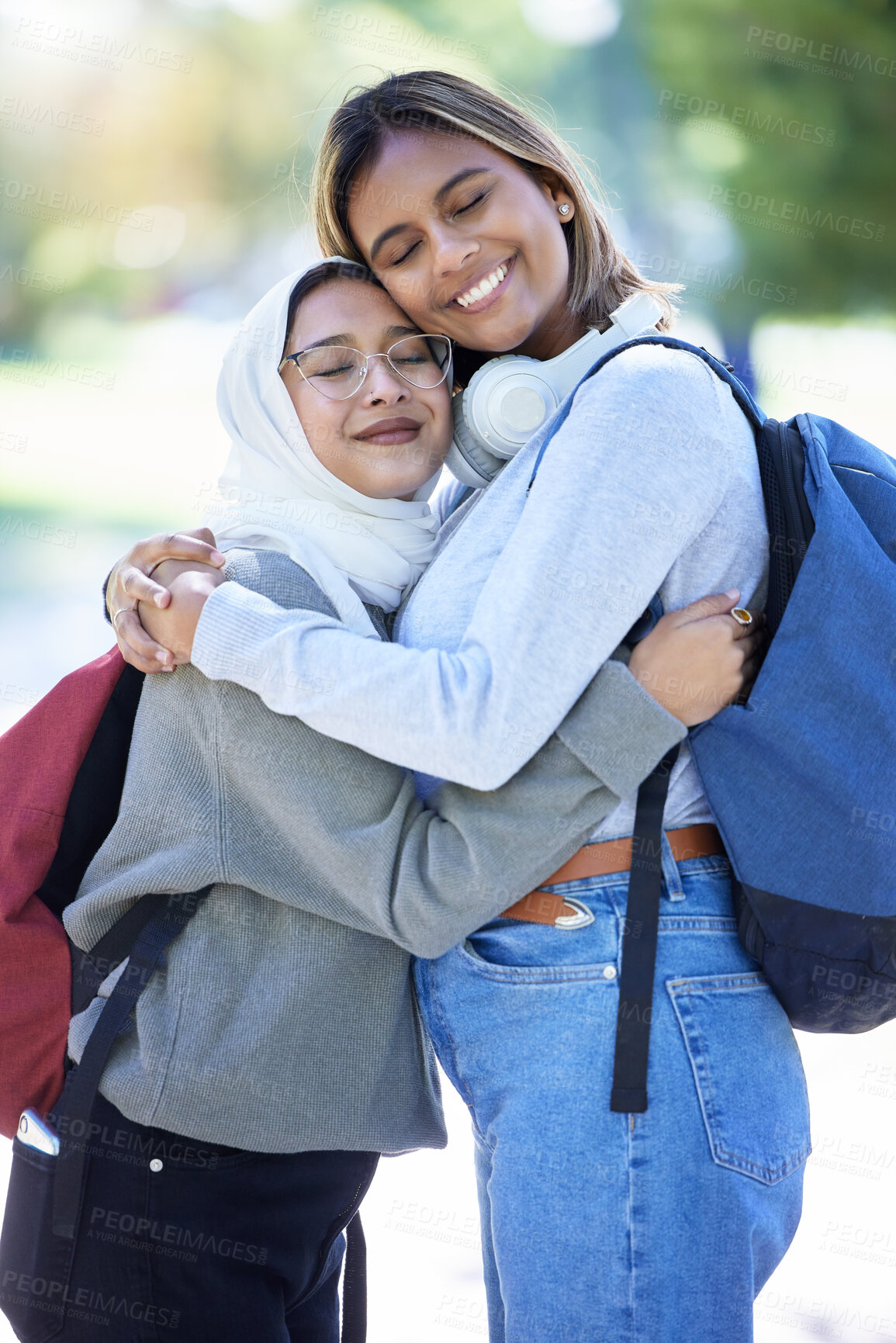 Buy stock photo Islamic students, backpack or hug in park, garden or school campus for bonding, friends acceptance or community support. Smile, happy or Muslim women in embrace, fashion hijab or university college