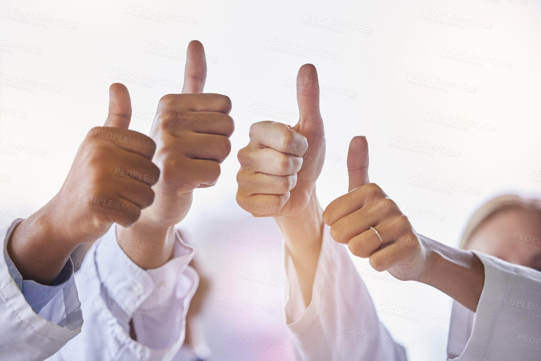 Buy stock photo Doctor, group thumbs up and teamwork with hands, celebration and motivation in hospital for healthcare. Man, woman and medic team building with support, solidarity and diversity in clinic workplace