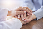 Hands, doctor and patient at desk for comfort, talking and communication for bad news, mental health and support. Therapist woman, helping hand and together for empathy, care and wellness in hospital