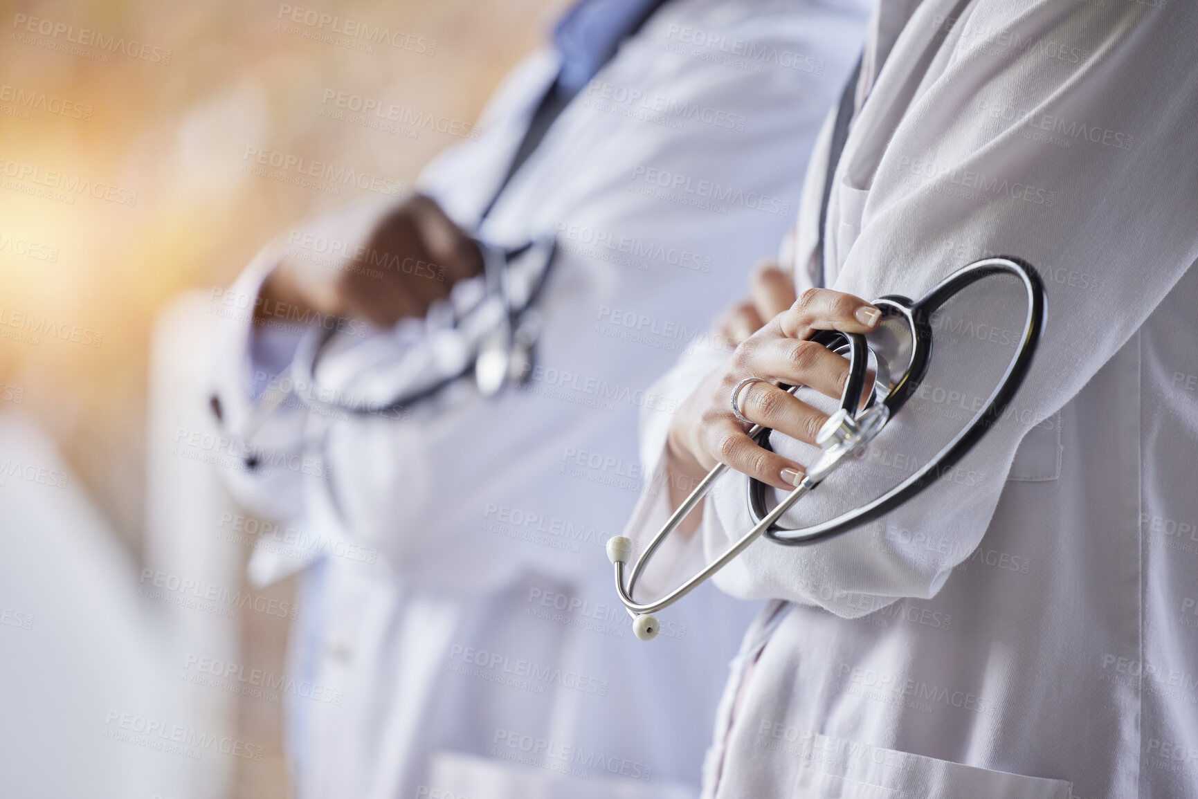 Buy stock photo Healthcare, stethoscope and hands of doctors with crossed arms for trust, medical care and consulting. Hospital mockup, wellness and health worker team for cardiology, insurance and medicare tools