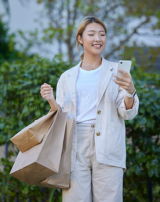 Buy stock photo Bags, shopping and Asian woman typing with phone outdoors after buying at mall. Technology, 5g cellphone and smile of happy female with mobile smartphone for social media, sales deals or discount.