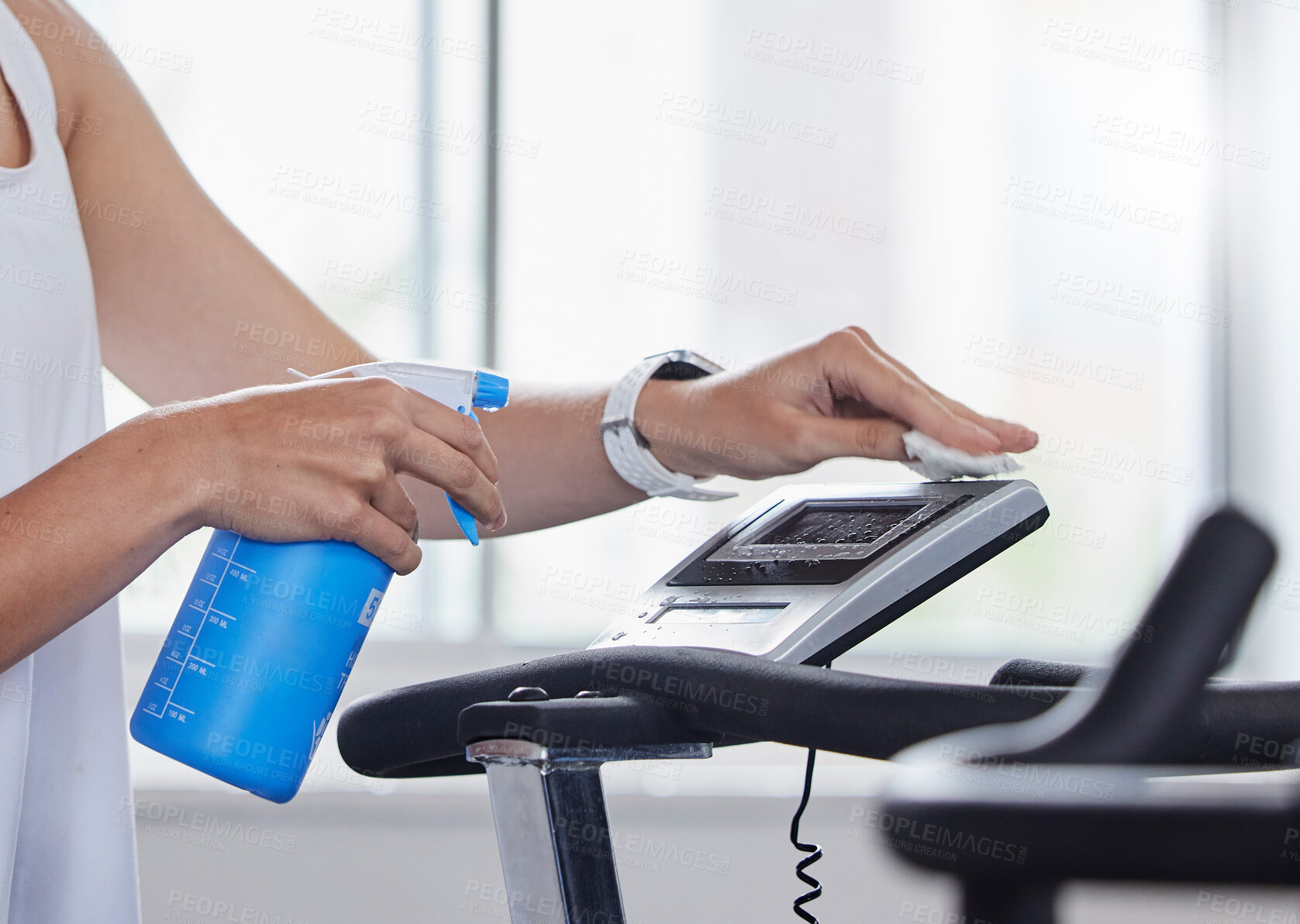 Buy stock photo Sanitizer, disinfect and fitness person cleaning gym surface before exercise, workout and training for health and wellness. Hygiene, wipe and anti virus on a treadmill by hand spray equipment clean