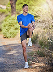 Fitness, stretching legs and man in nature getting ready for running, workout or training. Sports health, thinking or male athlete warm up or preparing to start cardio, exercise or jog for wellness