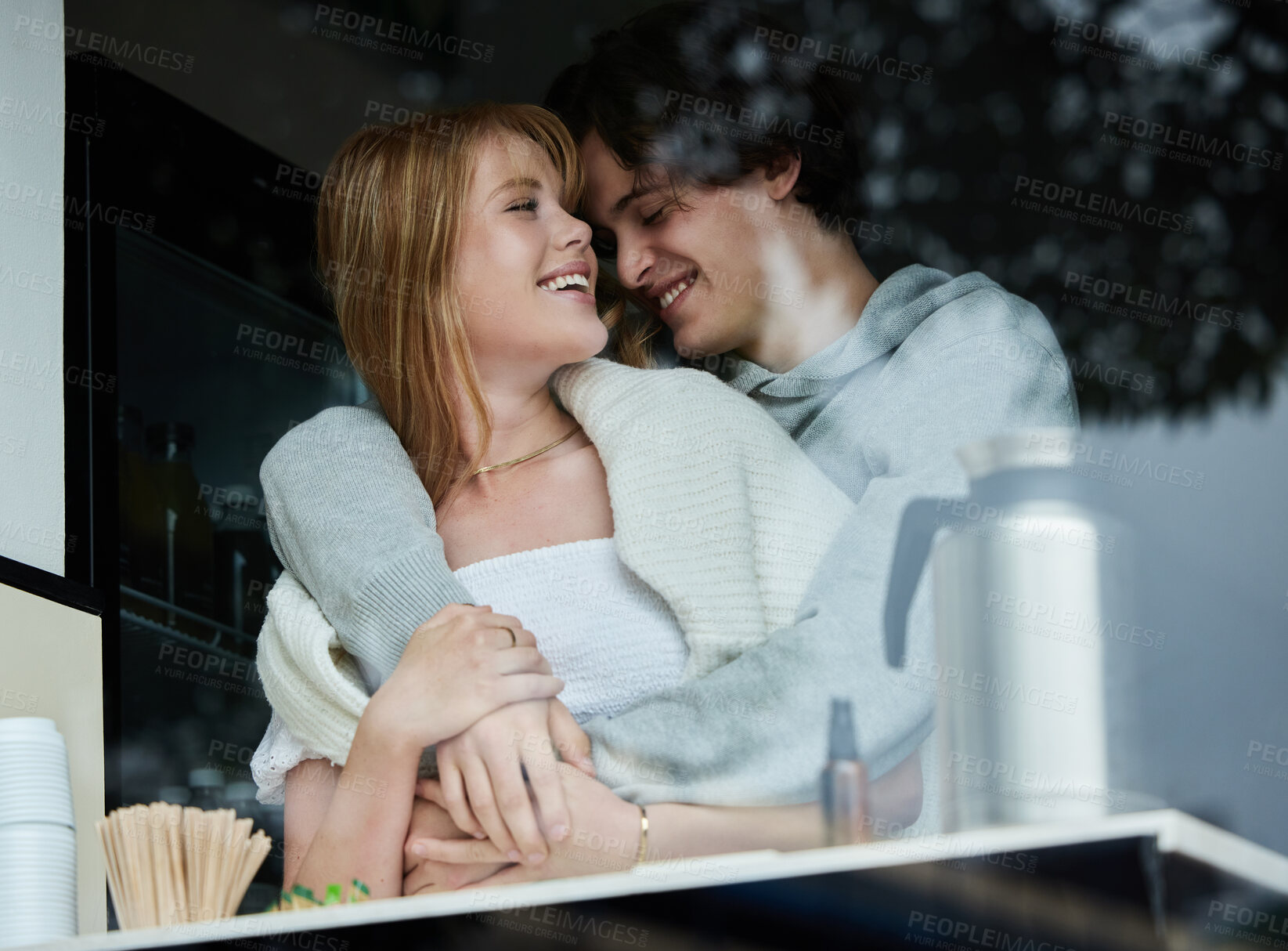 Buy stock photo Gen z, couple and kitchen window on date together with love, care and hug while laughing. College student, relax and happiness of a teen man and girl with a happy smile from teenager relationship