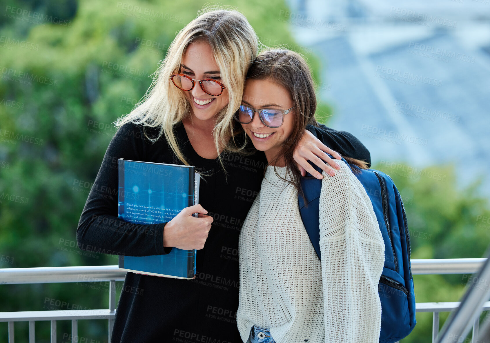 Buy stock photo Education, students and women hug, support and happiness outdoor, campus and bonding. Female academics, girls and happy friends embrace, solidarity and teamwork with smile, affection and motivation