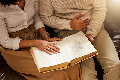 Buy stock photo Bible, hands and reading with a black couple together in their home for religion, faith or belief in God. Jesus, pray or book with a christian man and woman learning about the spiritual christ