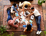 Teamwork, creative and overhead with a designer team lying on the floor while working on a project. Collaboration, startup or ideas with a group of young people working in advertising or marketing