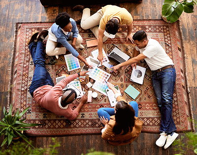 Buy stock photo Teamwork, creative and overhead with a designer team lying on the floor while working on a project. Collaboration, startup or ideas with a group of young people working in advertising or marketing