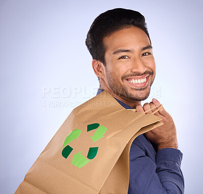 Buy stock photo Man in portrait, happy and recycling paper bag, environment and sustainable shopping on studio background. Eco friendly, green and climate change awareness in retail, sustainability and recycle logo