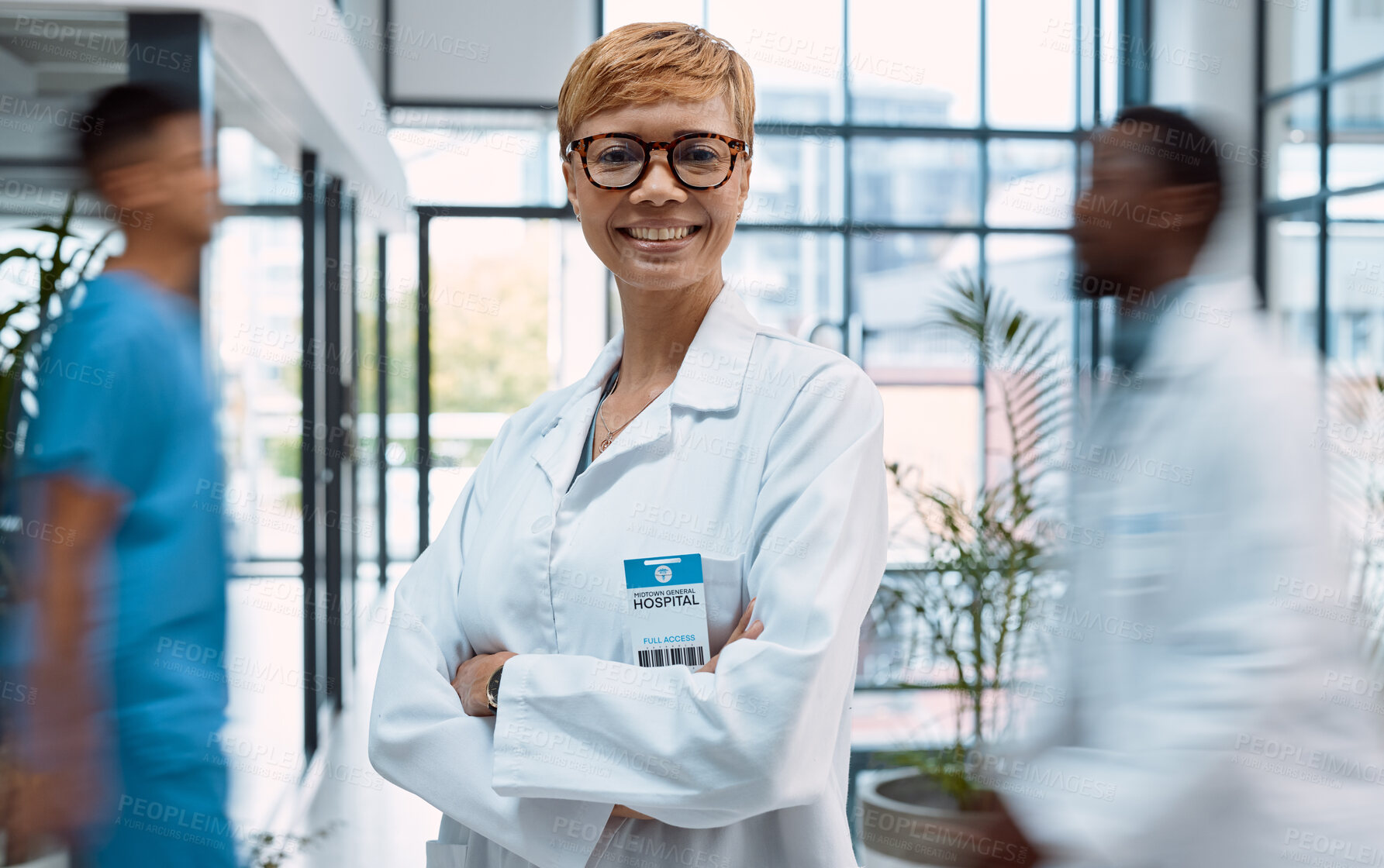 Buy stock photo Portrait, healthcare and motion blur with a doctor black woman standing arms crossed in a busy hospital. Medical, insurance and trust with a female medicine professional in a clinic for treatment