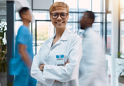 Buy stock photo Portrait, doctor and black woman in a busy hospital standing arms crossed with motion blur. Healthcare, leadership and trust with a female medicine professional in a clinic for health treatment